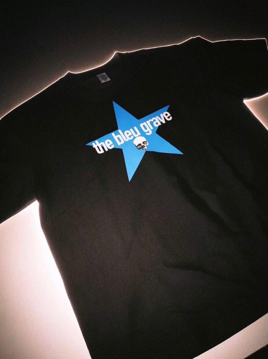 Black Bleu Grave t-shirt with a blue star design reading "the bleu grave" and a small skull graphic.